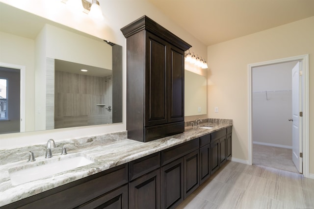 bathroom with vanity and a shower