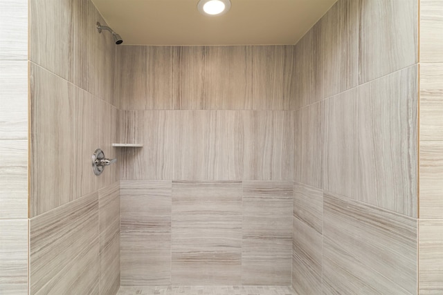 bathroom with a tile shower