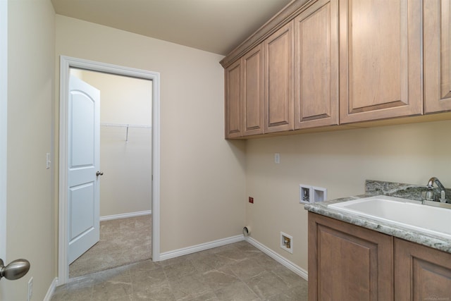 clothes washing area featuring hookup for a washing machine, cabinets, and sink