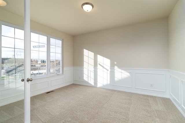 unfurnished room with light carpet