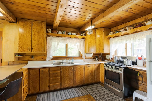 kitchen featuring stainless steel gas stove, wood ceiling, beam ceiling, and sink