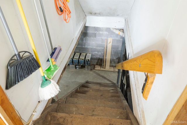 stairway with concrete flooring