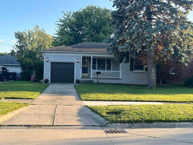 ranch-style home featuring a garage, a front yard, and covered porch