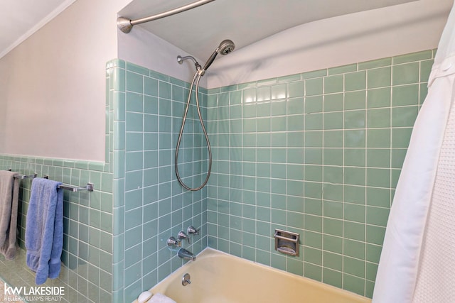 bathroom featuring tile walls, ornamental molding, and shower / bath combo