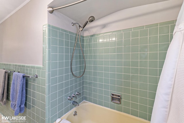 full bath with a wainscoted wall, tile walls, and shower / tub combo with curtain