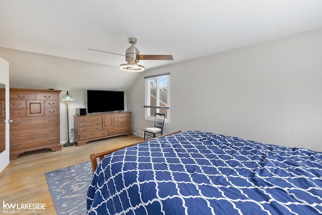 bedroom featuring vaulted ceiling, wood finished floors, and a ceiling fan