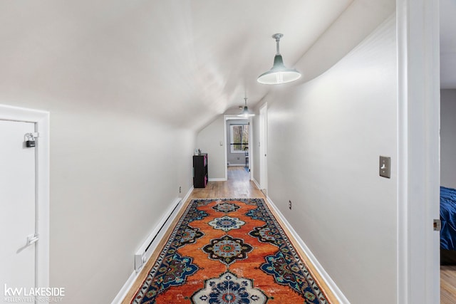 hall featuring lofted ceiling, a baseboard radiator, and light hardwood / wood-style flooring