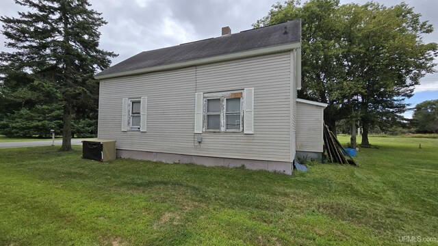 view of property exterior with a yard