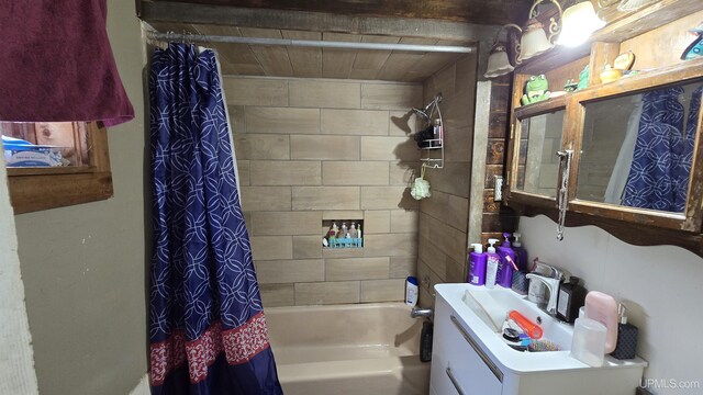 bathroom featuring vanity and shower / bathtub combination with curtain