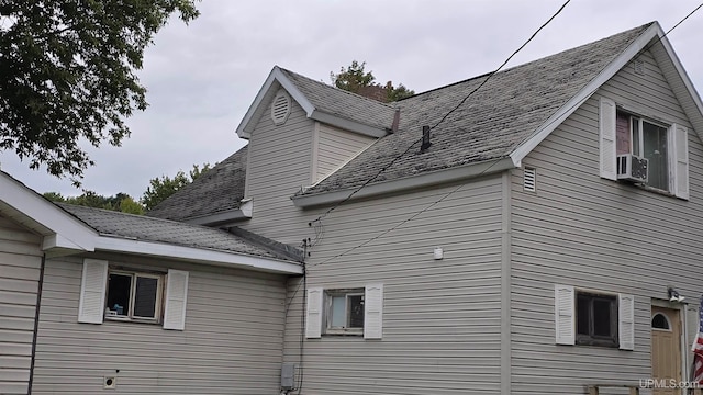 view of side of property with cooling unit