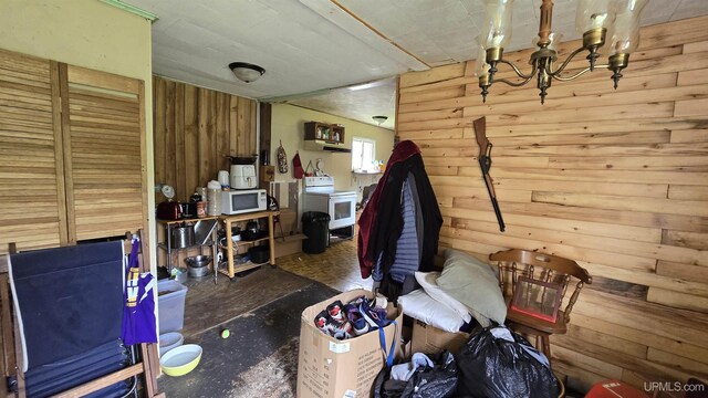 miscellaneous room featuring washer / dryer and wood walls