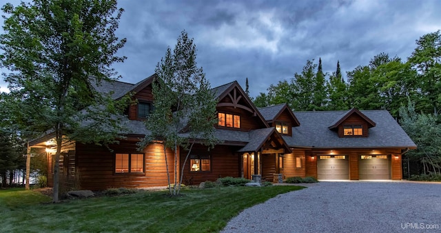 log home featuring a garage and a front yard