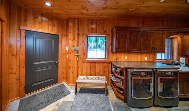 laundry room with wood walls, separate washer and dryer, cabinets, and wooden ceiling