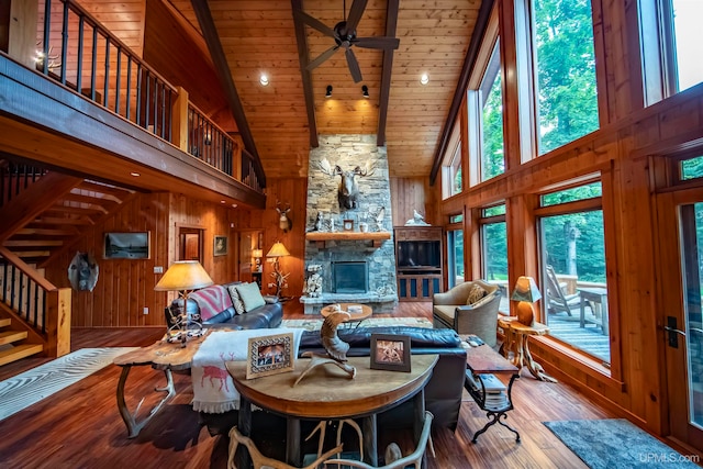 living room with ceiling fan, high vaulted ceiling, hardwood / wood-style flooring, and a fireplace