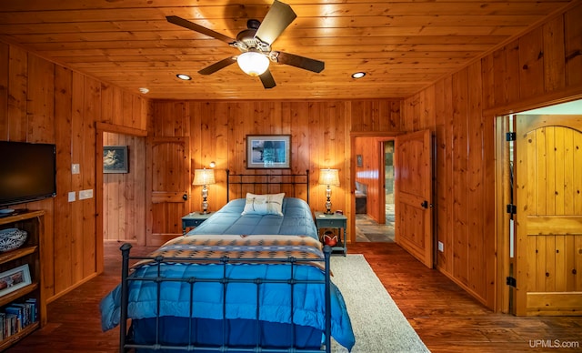 bedroom featuring wooden ceiling, dark wood-type flooring, wood walls, and ceiling fan