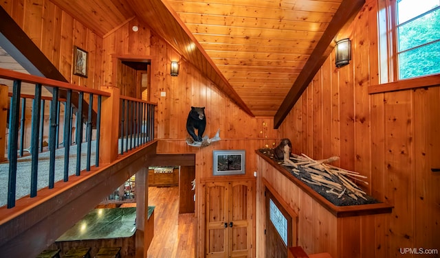 interior space featuring wooden walls, wooden ceiling, and vaulted ceiling