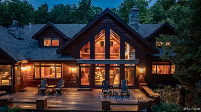 back of house featuring a wooden deck