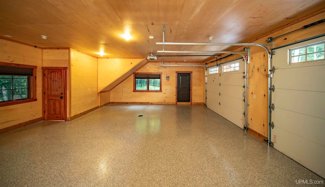 garage featuring a garage door opener and wood ceiling