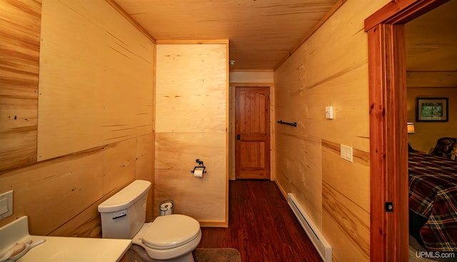 bathroom with toilet, wooden walls, wood-type flooring, a baseboard radiator, and wood ceiling