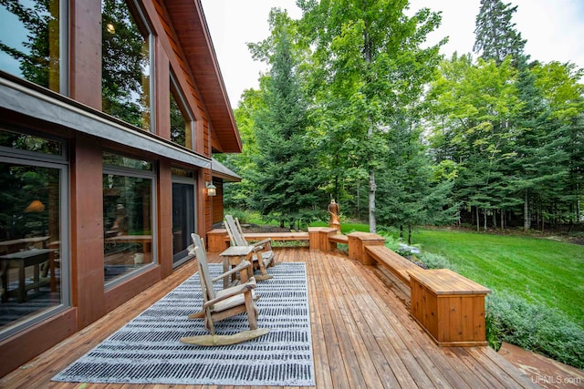 wooden deck featuring a yard