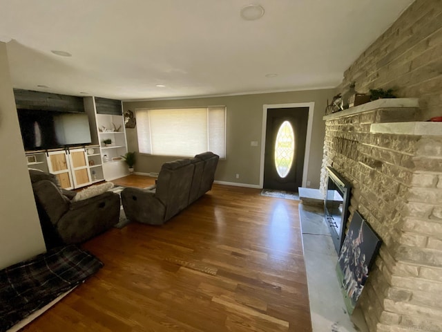 living room with hardwood / wood-style flooring and a fireplace