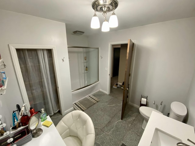 bathroom with vanity, toilet, and a notable chandelier