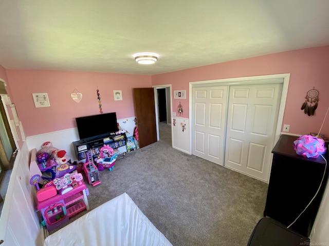 carpeted bedroom with a closet