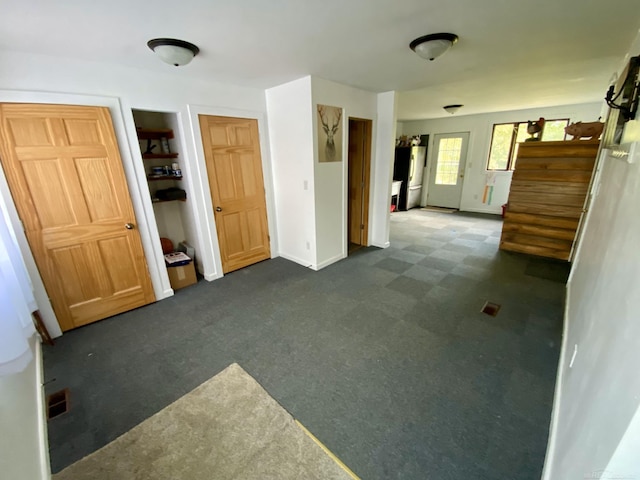 interior space with dark colored carpet