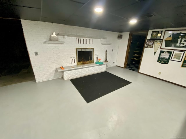 living room featuring a fireplace and concrete floors