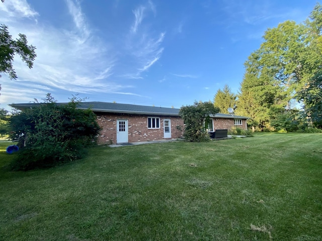 rear view of house with a lawn