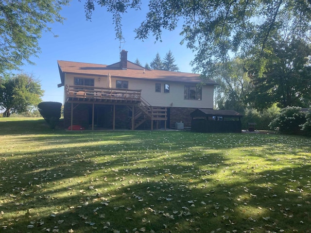 rear view of house featuring a wooden deck, a yard, and central AC unit