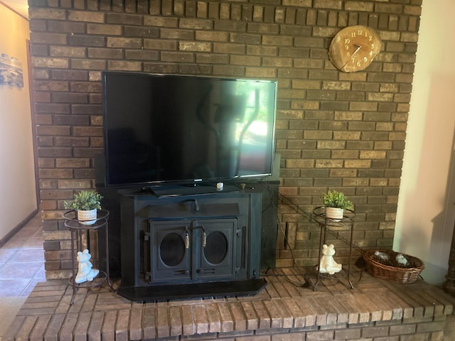 details featuring a wood stove and tile patterned floors