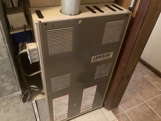 interior details with tile patterned flooring and heating unit