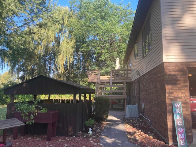 view of property exterior with a gazebo and central air condition unit