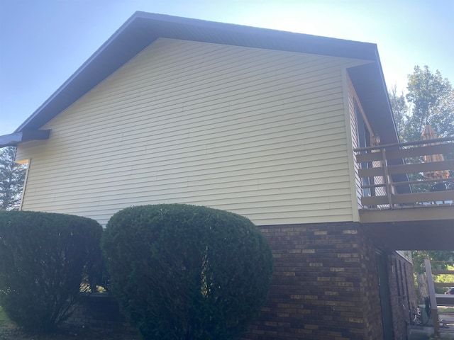 view of side of home featuring a balcony