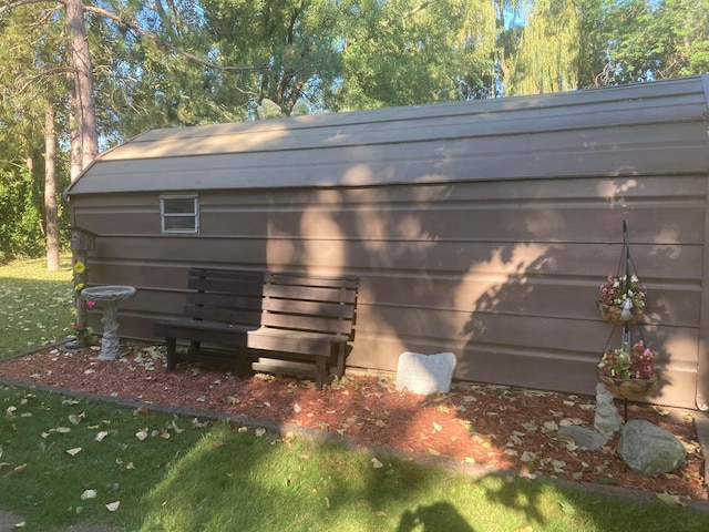 exterior space with a lawn and a shed