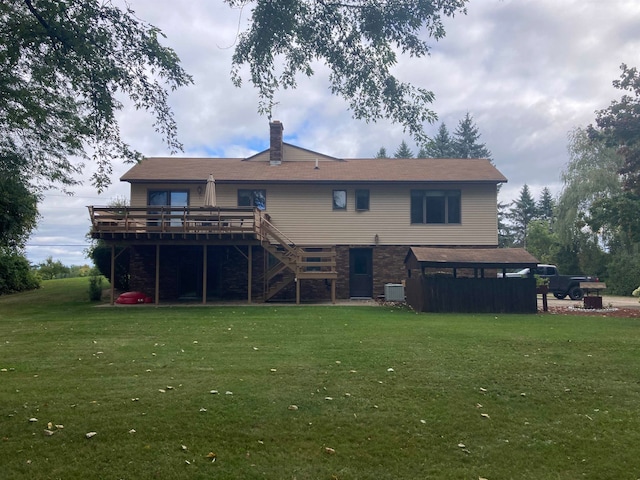 rear view of house with cooling unit, a lawn, and a deck