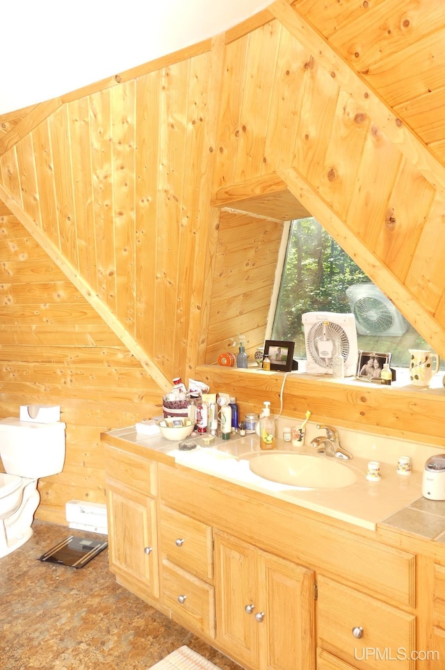 bathroom with vanity and wood walls