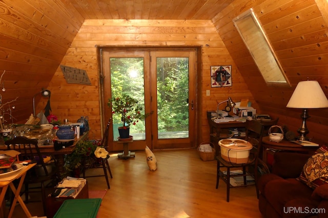 interior space with wooden ceiling, plenty of natural light, wood finished floors, and vaulted ceiling