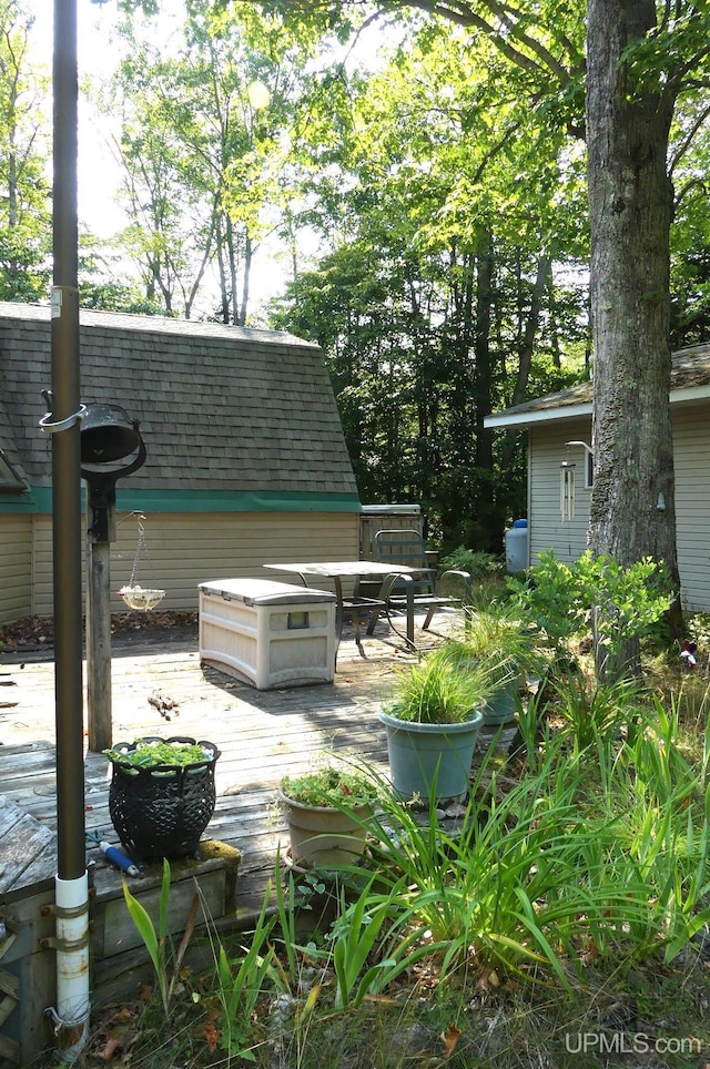 view of patio featuring an outdoor structure and a deck