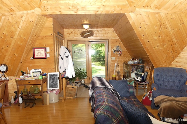 living room featuring vaulted ceiling, wood walls, wood ceiling, and wood finished floors