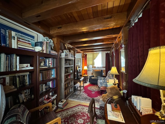 sitting room with beamed ceiling, wood-type flooring, and wood ceiling