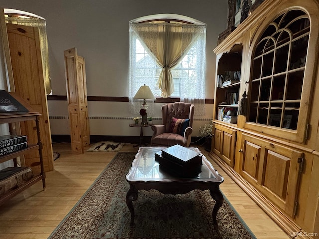 living area featuring light wood-type flooring and radiator