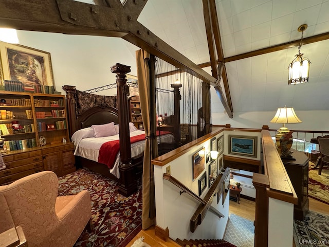 bedroom featuring light hardwood / wood-style flooring and lofted ceiling