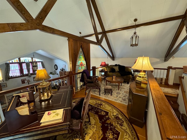 living room featuring vaulted ceiling with beams and wood-type flooring