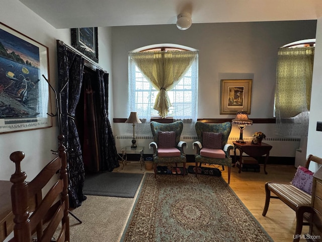 sitting room with wood-type flooring and radiator