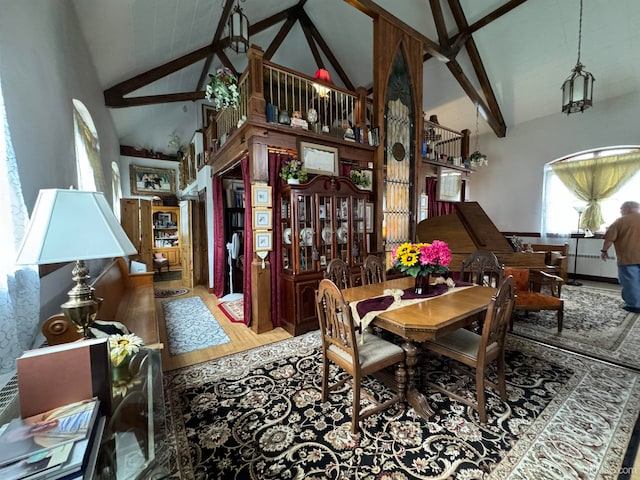 dining area with beamed ceiling, hardwood / wood-style flooring, and high vaulted ceiling