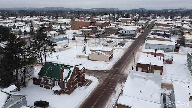 snowy aerial view featuring a mountain view