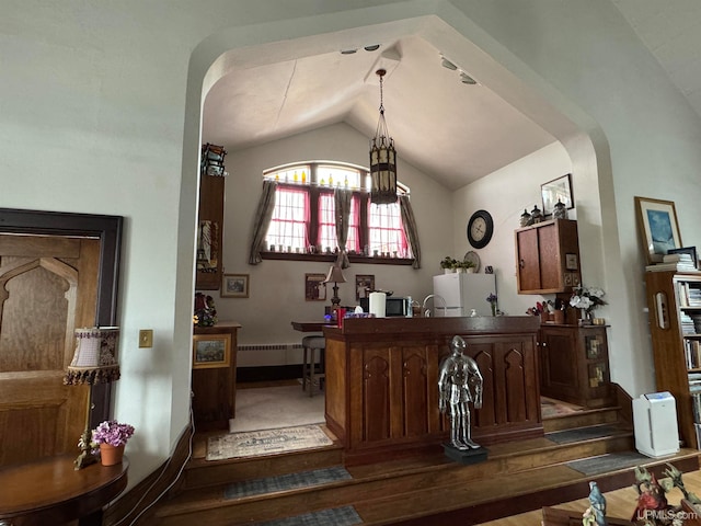 bar featuring hardwood / wood-style floors, white fridge, and lofted ceiling