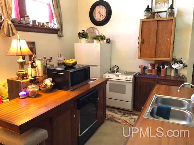 kitchen with white range with electric cooktop, sink, black dishwasher, butcher block countertops, and wall oven